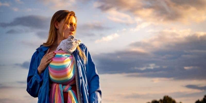 Woman wearing a baby wrap outside