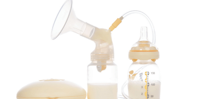 Electric breast pump with a bottle half full of breast milk